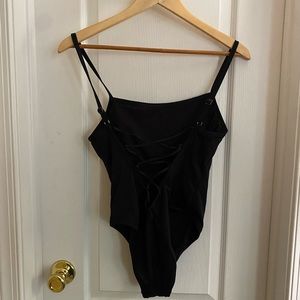 Black one piece bathing suit with back lace up strap size unknown
